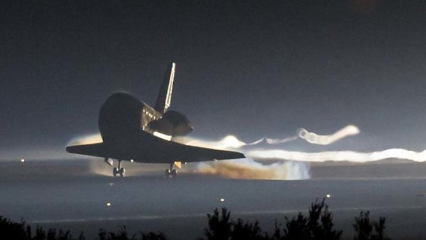 The space shuttle Atlantis lands at Kennedy Space Center in Florida, ending its 13-day mission.