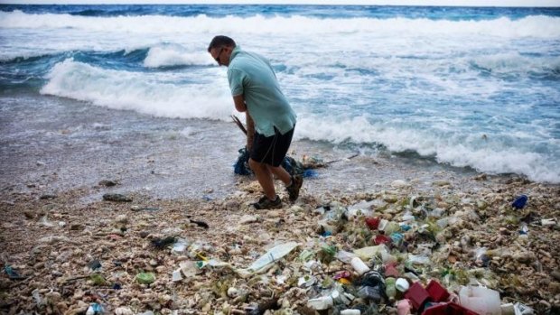 Outgoing administrator of Christmas Island Jon Stanhope at Dolly Beach, which is littered with plastic rubbish.