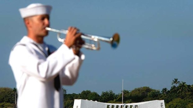 A sailor plays Taps at the USS Arizona memorial.