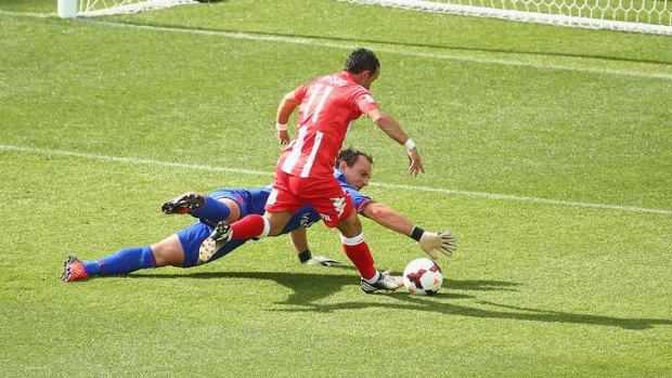 Adelaide United goalkeeper Eugene Galekovic blocks an attempt on goal by Mifsud during round eight.