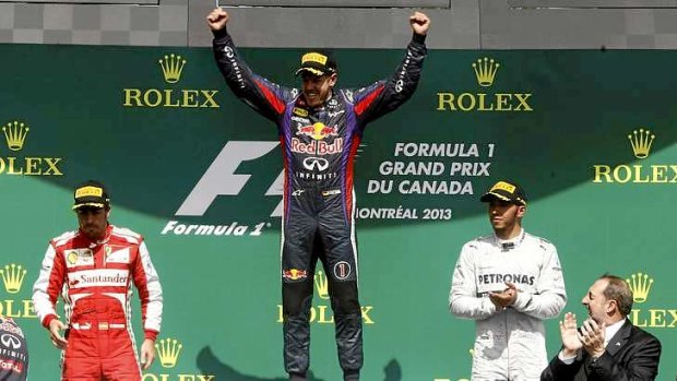 Red Bull Formula 1 driver Sebastian Vettel (centre), of Germany, celebrates on the podium after winning the Canadian F1 Grand Prix at the Circuit Gilles Villeneuve in Montreal June 9, 2013. Standing next to Vettel are second-placed Ferrari driver Fernando Alonso (left), of Spain, and third-placed Mercedes driver Lewis Hamilton, of Britain.