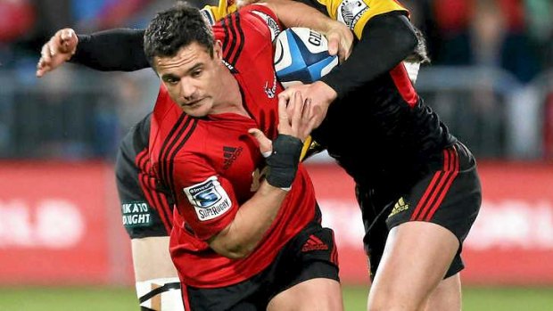 Crusaders five-eighth Dan Carter squeezes past the tackle of Michael Fitzgerald and Tawera Kerr-Barlow of the Chiefs.