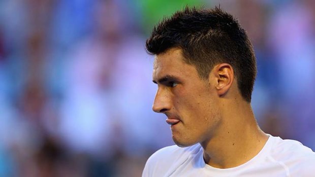 Caught in the middle: Bernard Tomic.
