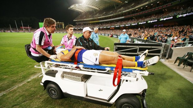 Andrew Gaff is taken from the field after the head high clash.