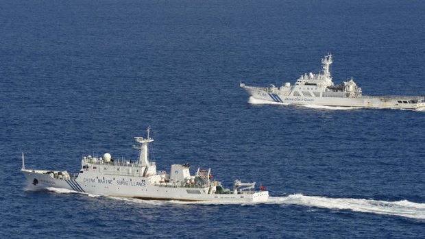 A Chinese surveillance ship  sails in front of a Japan Coast Guard vessel near disputed islands in the East China Sea.