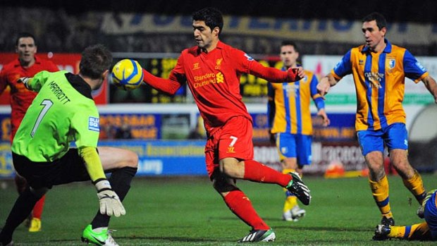 Decisive moment ... Luis Suarez handles the ball in the lead up to his goal against Mansfield Town.
