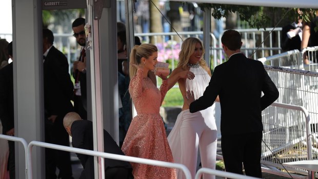 Guests go through security screening as they arrive for the screening of Ismael's Ghosts (Les Fantomes d'Ismael) and the opening gala of the 70th annual Cannes Film Festival.