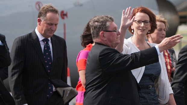 'Tell your fans what is going on': Prime Minister Julia Gillard arrives in Queenstown on Friday to meet with New Zealand's Prime Minister John Key (left).
