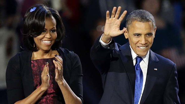 Four more years ... President Barack Obama and his wife Michelle acknowledge the crowd in Chicago.