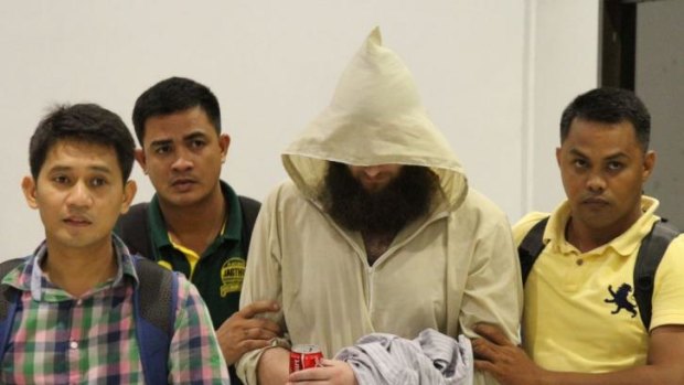 Musa Cerantonio escorted by Philippine immigration officers at Manila airport after his arrest.