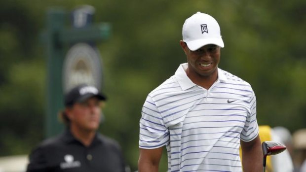Tiger Woods grimaces after his tee shot on the 17th hole.