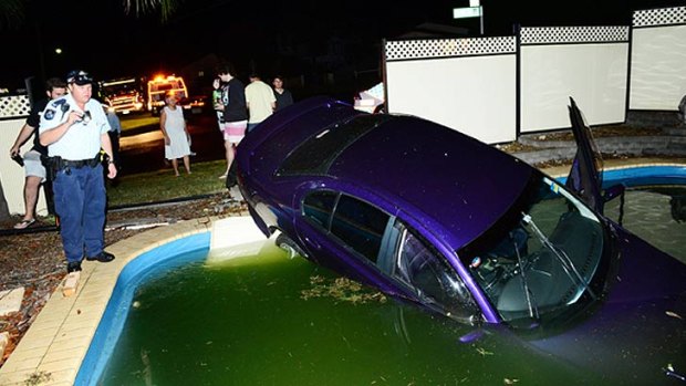 A car comes to rest in a pool in West Ipswich. Photo: David Nielsen/The Queensland Times