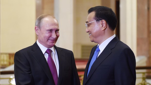 Chinese President Xi Jinping (right) greets Russian President Vladimir Putin to discuss more economic and military co-operation between the two countries.