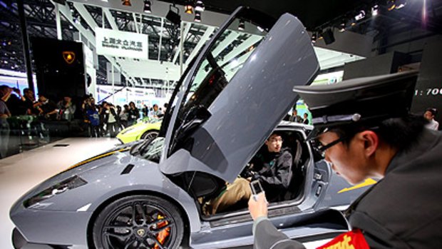 Motor show dreaming: Chinese motorists may aspire to Lamborghinis (above) but the government hopes they will find the Saic E1 electric car more practical.