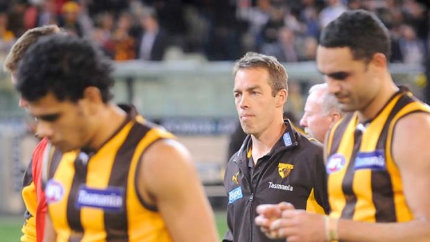 A grim Alastair Clarkson walks off with the players after the gut-wrenching defeat.