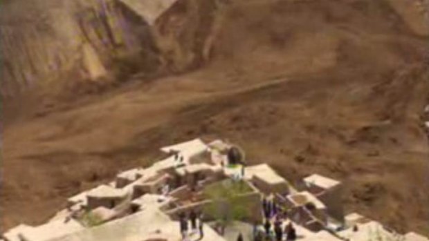 This image made from an AP video shows people searching for survivors after a massive landslide buried a village in Badakhshan province in north-eastern Afghanistan.