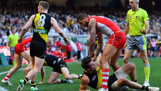 Lance Franklin wrestles with Alex Rance after his bump on Connor Menadue sparked a melee.