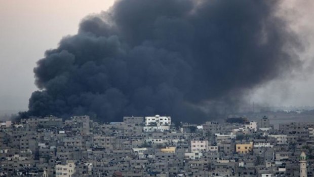 Smoke billows from a building hit by an Israeli air strike in Gaza.
