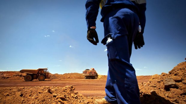 Diesel and dust … broken raw ore material is loaded into haul trucks at the Brockman 4 open-pit mine in WA's Pilbara region.