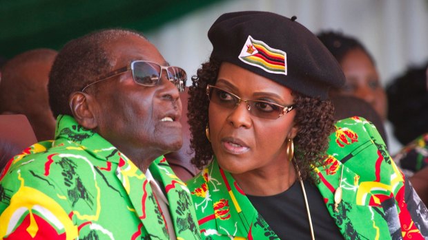 Zimbabwean President Robert Mugabe, left, and his wife Grace at a youth rally in June.