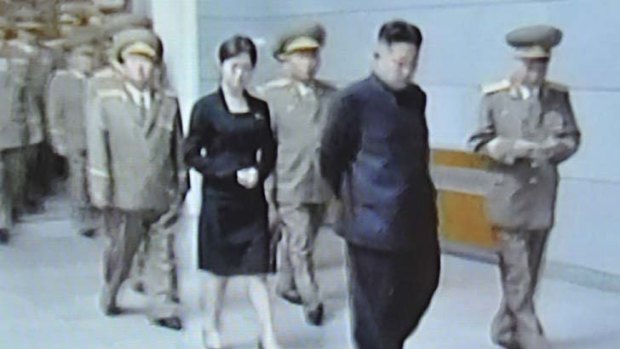Who is she? Kim Jong-un is pictured during a visit to  Kumsusan Palace with an unidentified woman.