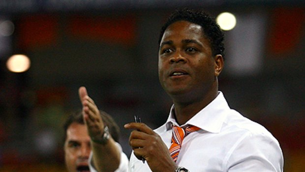 Former Dutch international player Patrick Kluivert and Roar coach Ange Postecoglou watch on eagerly from the sideline during the round 25 A-League match between the Roar and Sydney FC.