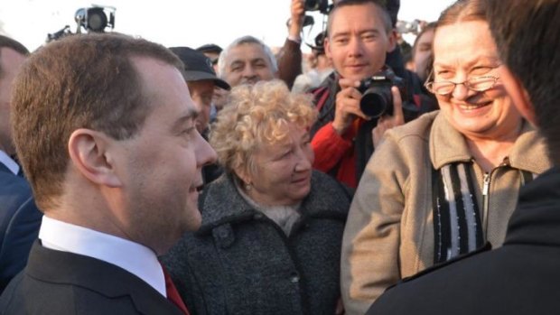 Russian Prime Minister Dmitry Medvedev, left, speaks to local citizens after a wreath laying ceremony at the World War II memorial in Sevastopol, in Crimea, Monday.