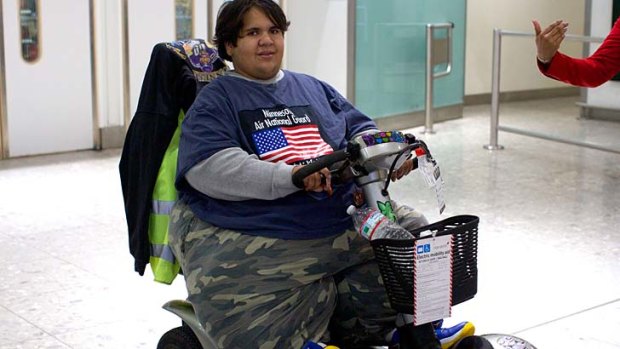 French Kevin Chenais, who was deemed too fat to fly, exits Heathrow Airport upon arrival on a plane from New York to London. Chenais has now been rejected by the Eurostar train in an attempt to get back to France.