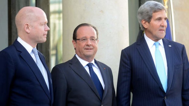 French President Francois Hollande welcomes British Foreign Secretary William Hague, left, and US Secretary of State John Kerry at the Elysee Palace.
