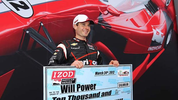 Will Power holds his winning cheque after he took pole position for the Grand Prix of St Petersburg.