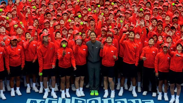 Chinese player Li Na poses with the Australian Open squad of 380 ball kids on Tuesday.