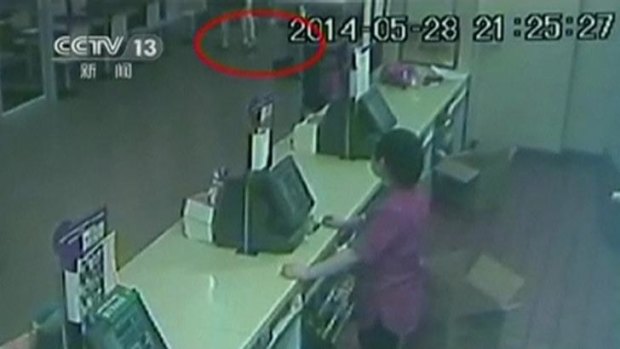 Security camera footage shows suspects attacking a woman (identified by red circle) at the McDonald's.