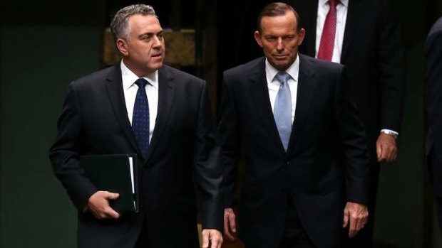 Big cuts: Treasurer Joe Hockey and Prime Minister Tony Abbott arrive to hand down the budget in the House of Representatives.