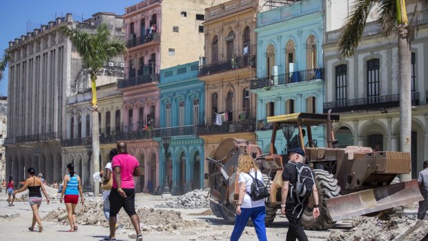 People walk amid renovation work in Havana, Cuba, ahead of a visit by Barack Obama.