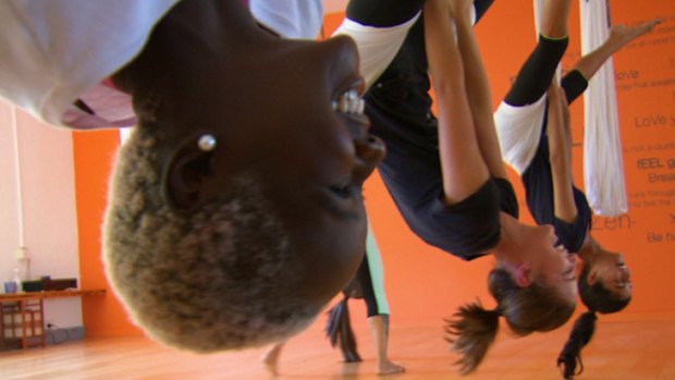 Hanging around: Ducky, Jade and Melissa try their hand at anti-gravity yoga.