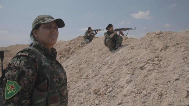 YPJ commander Suzdar Derik monitors trainee militia members.