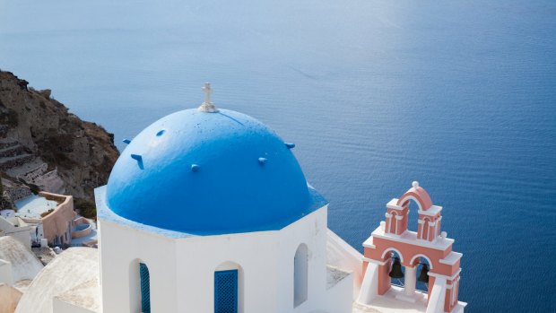 Coastal odyssey: An iconic blue-domed church on the Greek island of Santorini.
