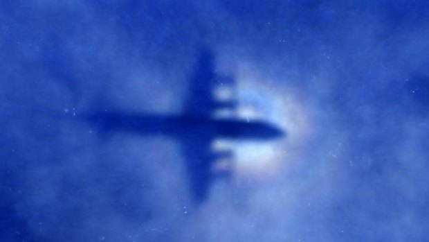 The shadow of a Royal New Zealand Air Force P3 Orion  can be seen on low-level clouds as it flies over the southern Indian Ocean looking for missing Malaysian Airlines flight MH370.