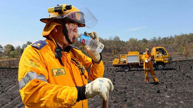John Bowles from the Ripley Valley Rural Fire Brigade takes a quick break while battling a fire last week.  <B><A href= www.qt.com.au/news/firies-put-to-the-test/1597408/ > Photo: Sarah Harvey, The Queensland Times </a></b>