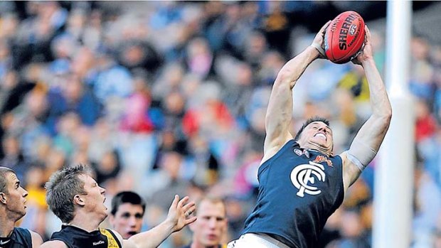 Full stretch: Carlton's Bret Thornton marks strongly over Jack Riewoldt yesterday.