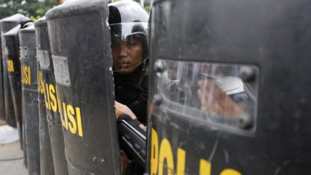 Brief skirmish: Indonesian police outside the Constitutional Court on Thursday.