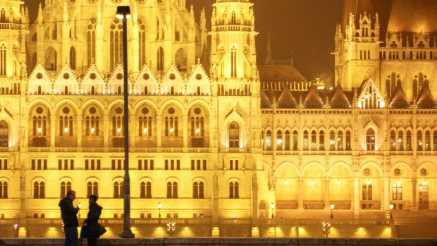 Romantic spot: A couple in front of parliament building, Budapest, Hungary.