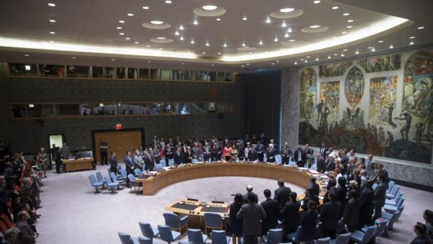 Members of the UN Security Council stand for a moment of silence.