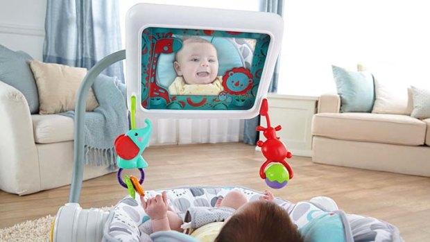 A baby sees their reflection using the Newborn-to-Toddler Apptivity Seat.