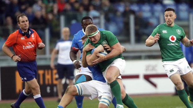 Tough grind: Ireland's John Ryan hits the line during the 26-16 Six Nations victory over Italy in Rome.
