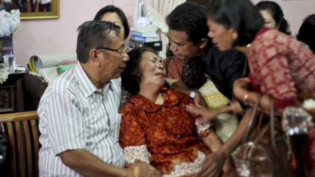 Distraught relatives of one of the passengers wait for news.