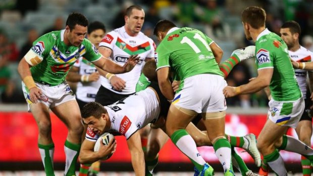 No serious damage: Sam Burgess falls awkwardly on his right shoulder during Souths’ win over the Raiders on Monday.