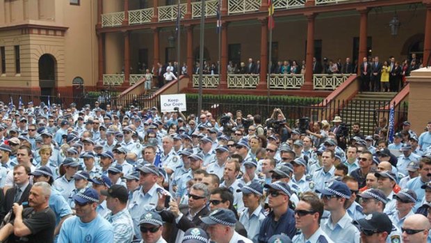 Angry blue line ... officers march in Macquarie Street yesterday in protest against government plans to cut compensation payouts from their death and disability scheme.