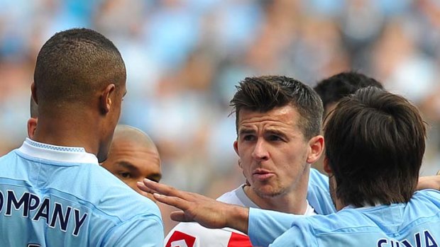 Joey Barton clashes with Manchester City's players.
