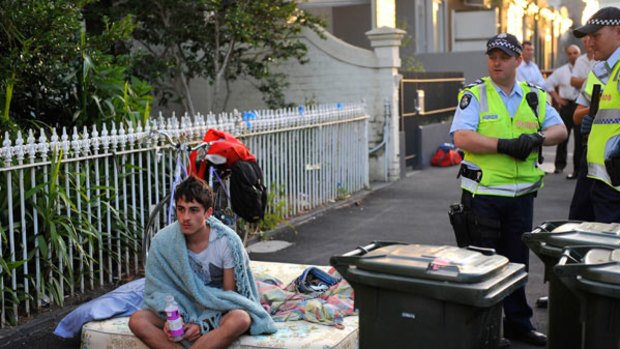 One of the squatters on the footpath outside the Faraday Street terraces after this morning's eviction.